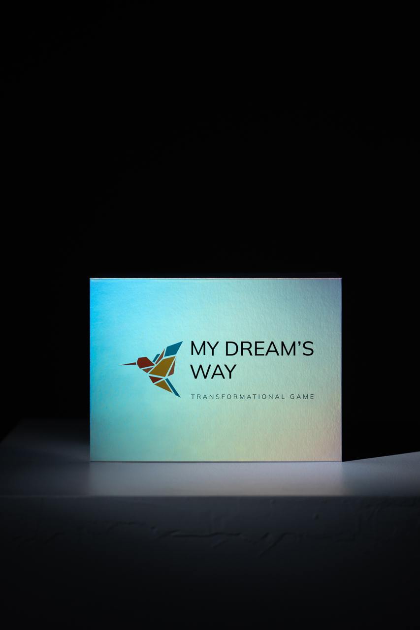 Cutia jocului transformațional My Dream's Way, luminată pe fundal întunecat